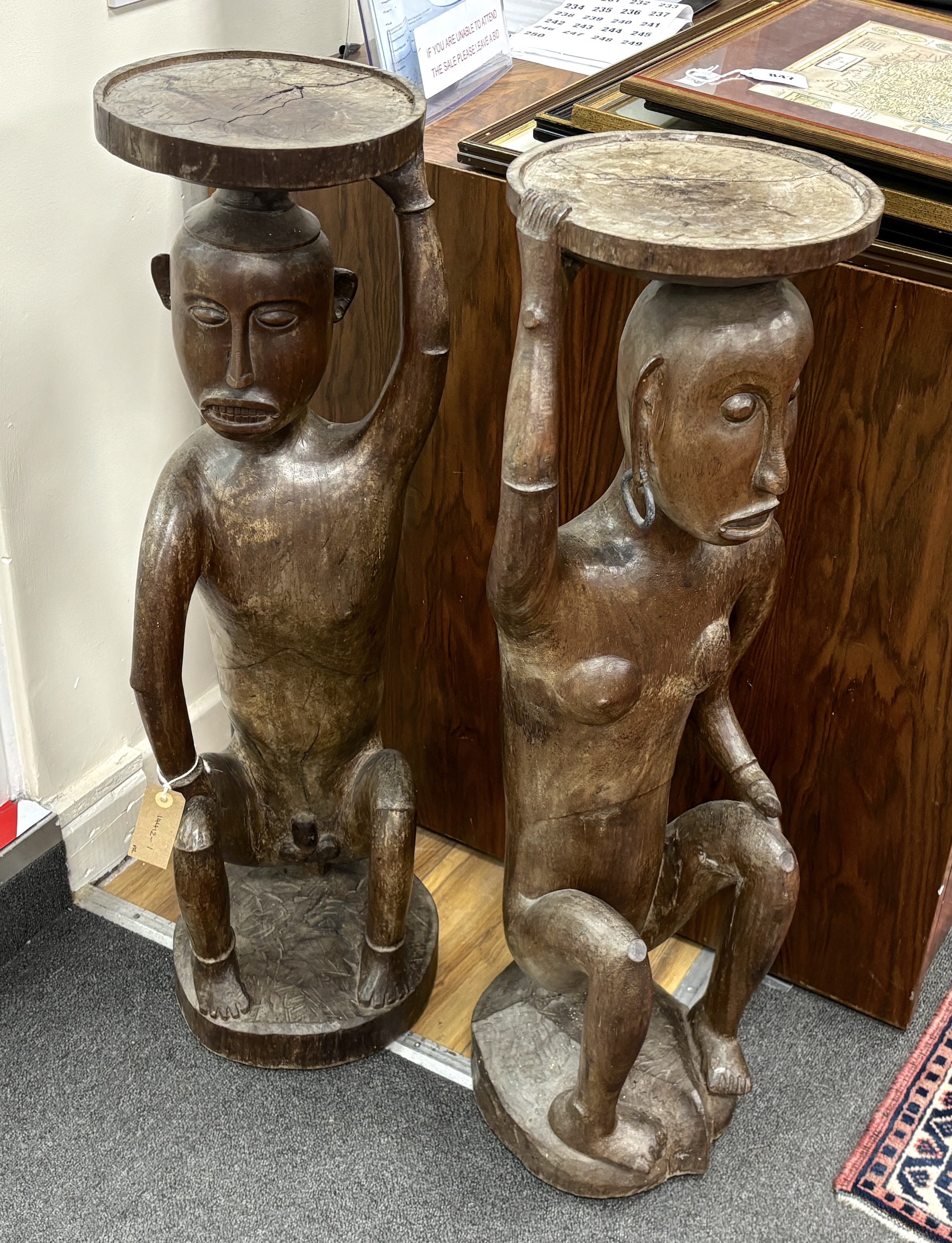 A pair of Sarawak carved hardwood figures. height 85cm